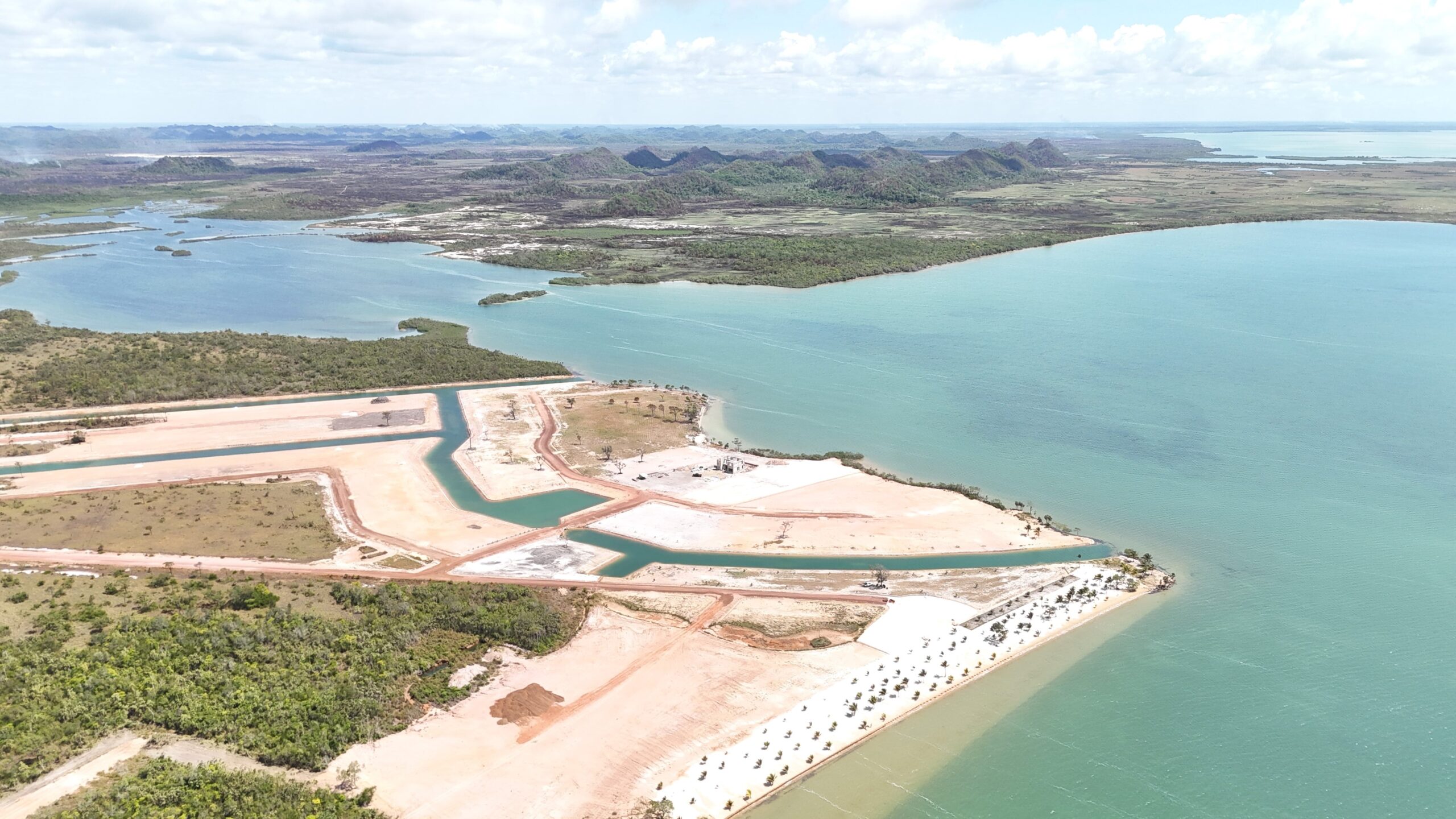 Aerial View of Land Development with Waterway and Green Landscape