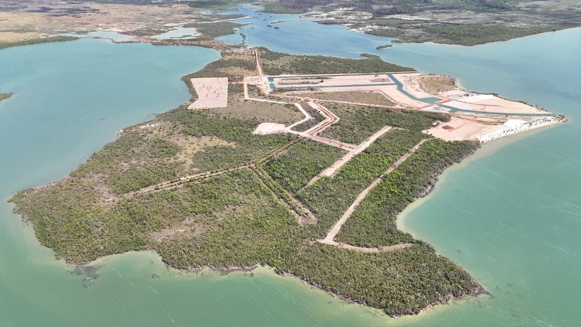 Aerial View of a Construction Site with Water and Land Development