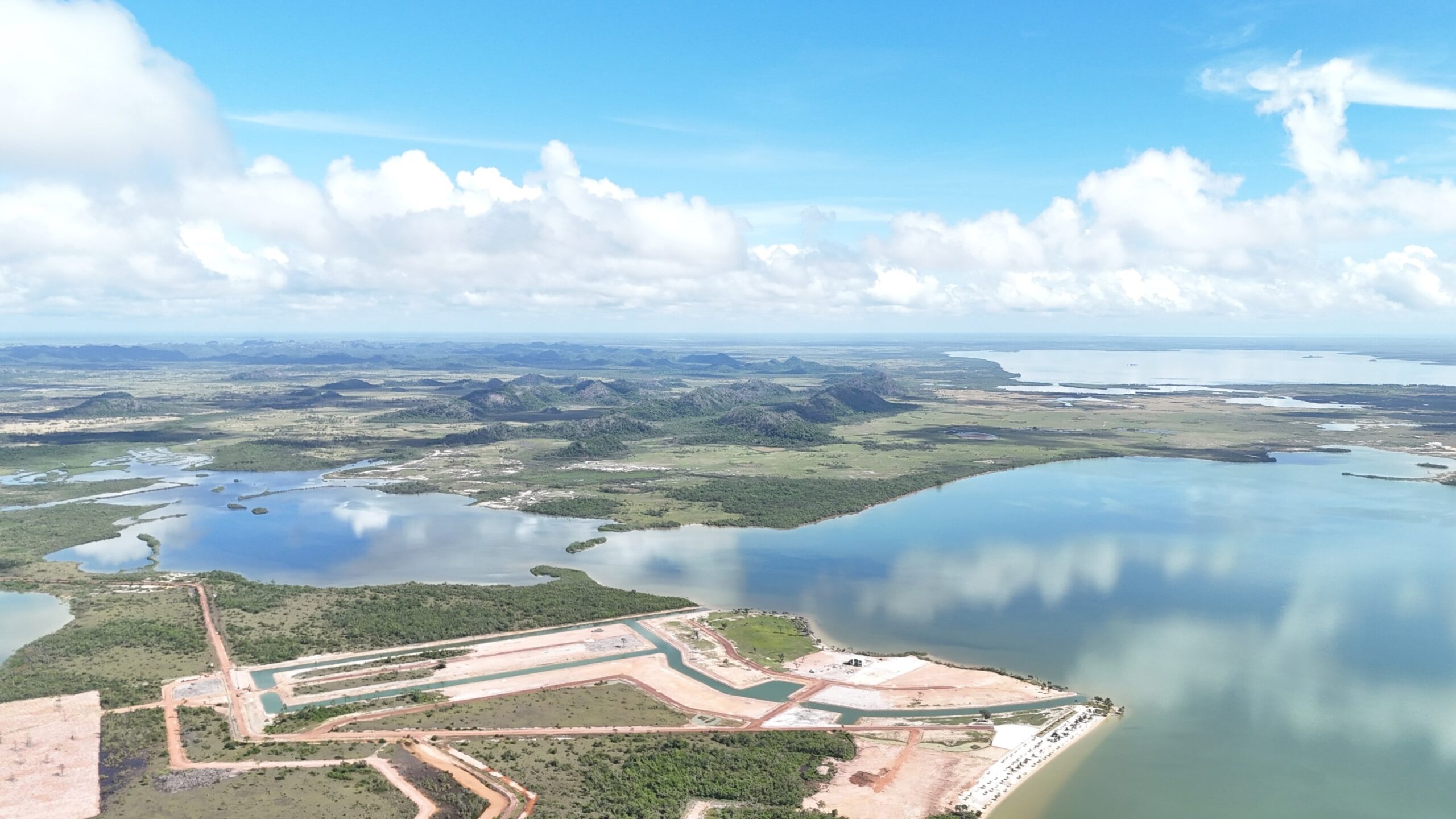 Aerial View of a Construction Site with Water and Land Development