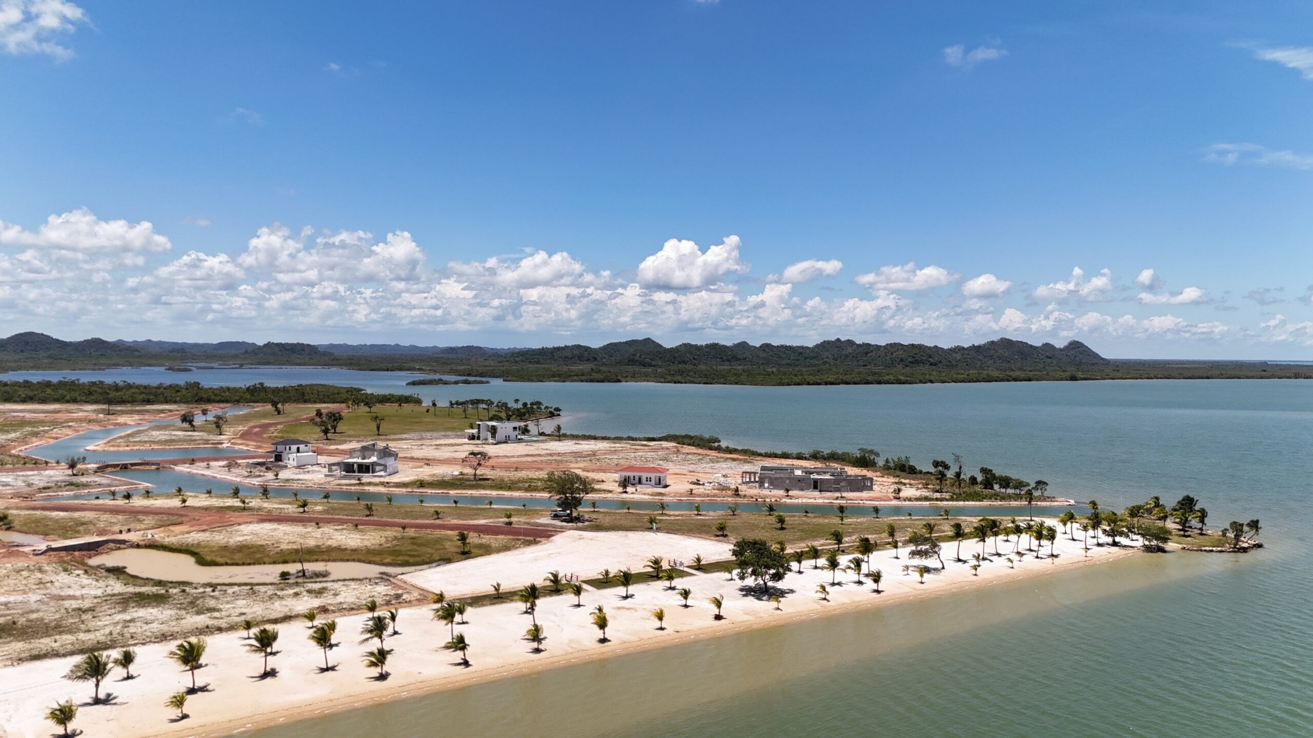 Beach and Homes in Phase 1 Aerial View of a Construction with Water and Land Development